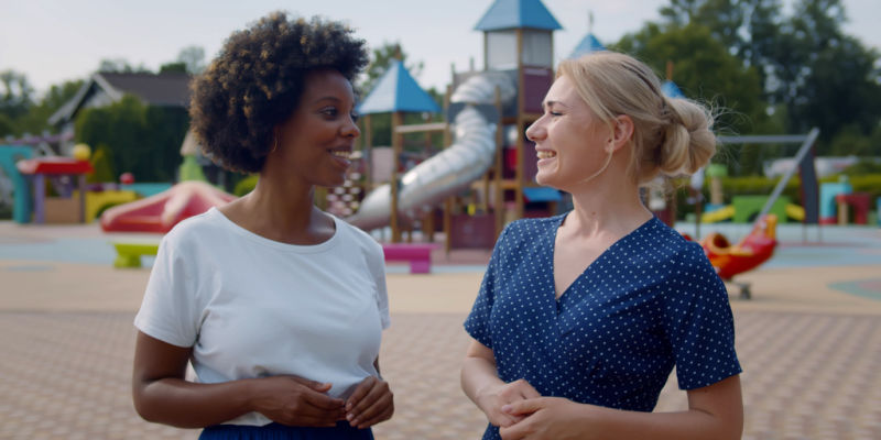 Mothers chat at amusement park