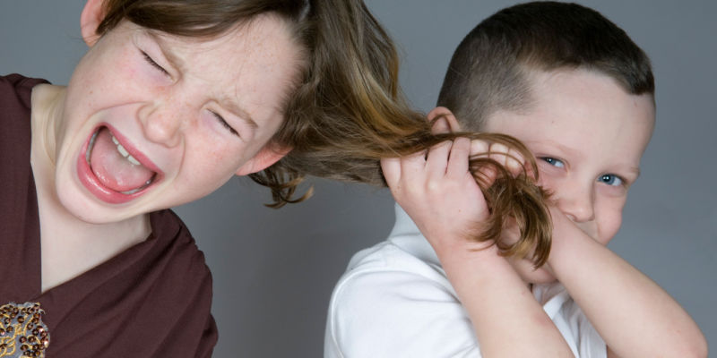 boy pulls girls hair