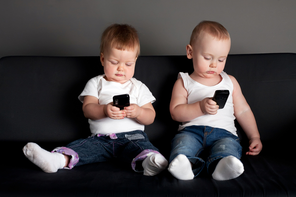 Babies with handheld mobile phones