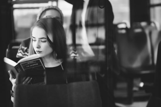 woman on bus reading book