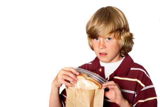 A boy is disgusted by his school lunch (example of bad school lunches)