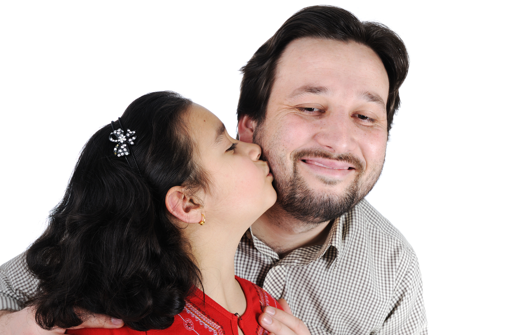 daughter kisses dad's cheek