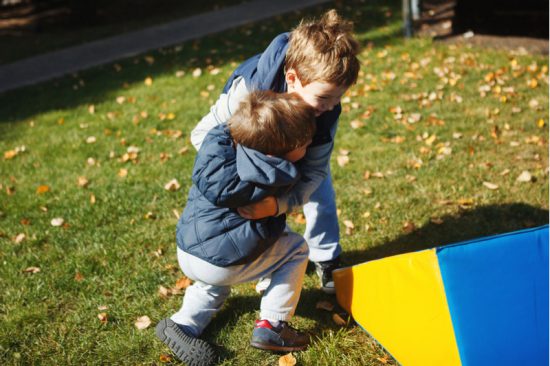 boys fighting in the park