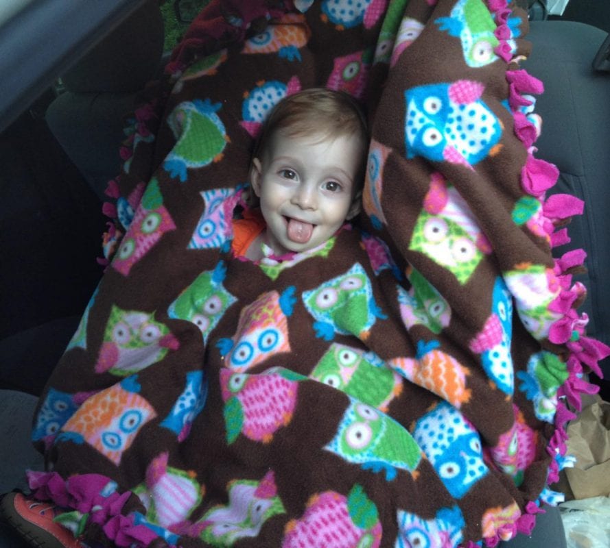 Fleece poncho in use over car seat/harness (photo credit: Saara Moskowitz)