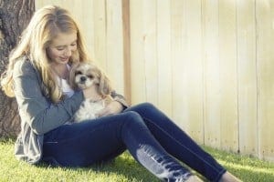 Teenager cuddling a lapdog