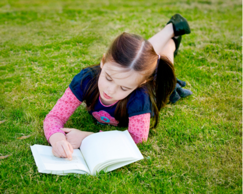 Girl follows in book with finger