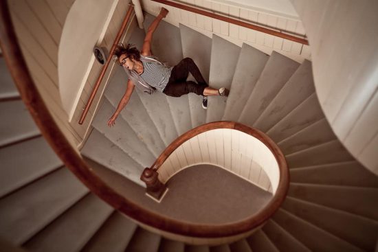 A man with Visual Processing Disorder (VPD) stumbles down the stairs