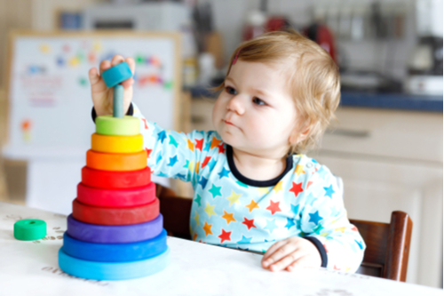 baby girl with stacking toy