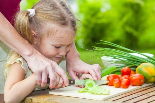 Little Girl Chops Vegetables