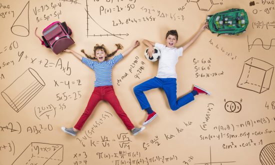 Boy and girl jumping against background of math formulae