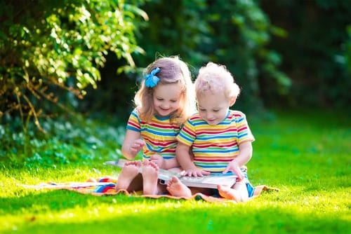 Two girls looking at a picture book.