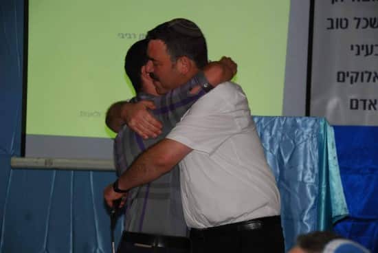 Hugging a student at graduation.