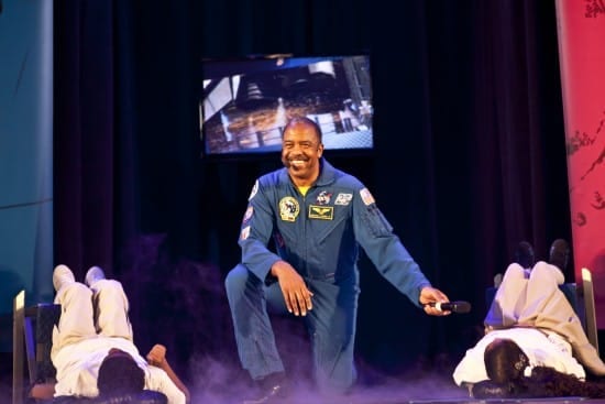 Dr. Harris on stage promoting The DREAM Tour in Harlem, allowing two students to experience the thrust of the rocket taking off! (courtesy)