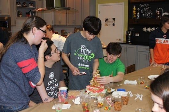 Making gingerbread houses with all the fixings (courtesy)