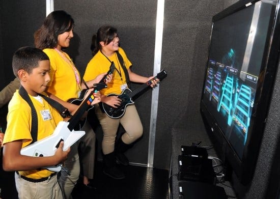 From left: Students Isaac Zuniga, Alondra Garcia and Abigal Garcia play Guitar Hero in the Game Truck following the RockIt! press conference at Marshall Middle School Thursday Oct. 11,2012. (Dave Rossman photo)