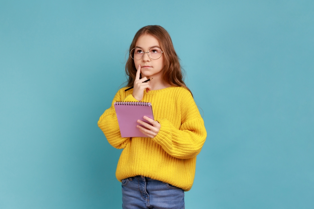 Portrait,Of,Little,Girl,Writing,In,Notebook,,Thinking,,Taking,Notes,