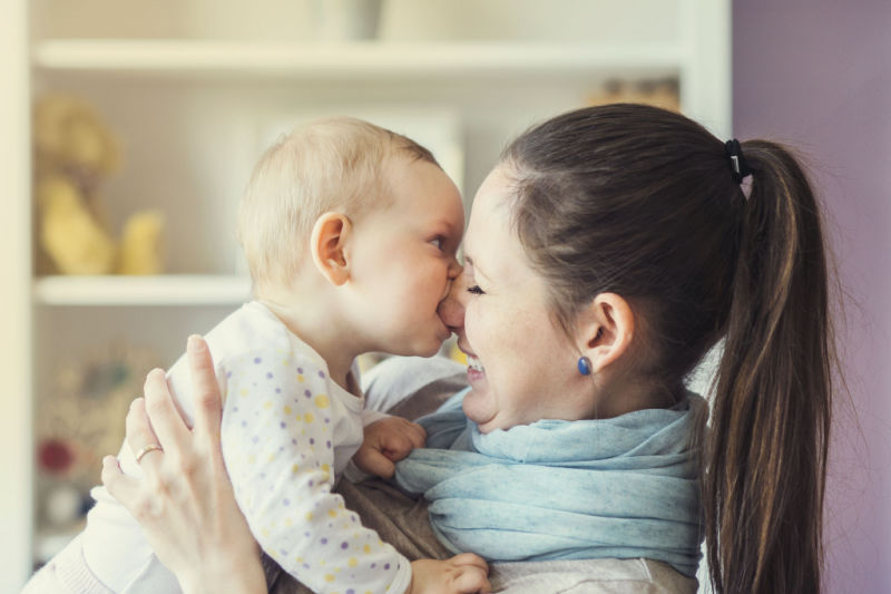 baby bites laughing mommy nose