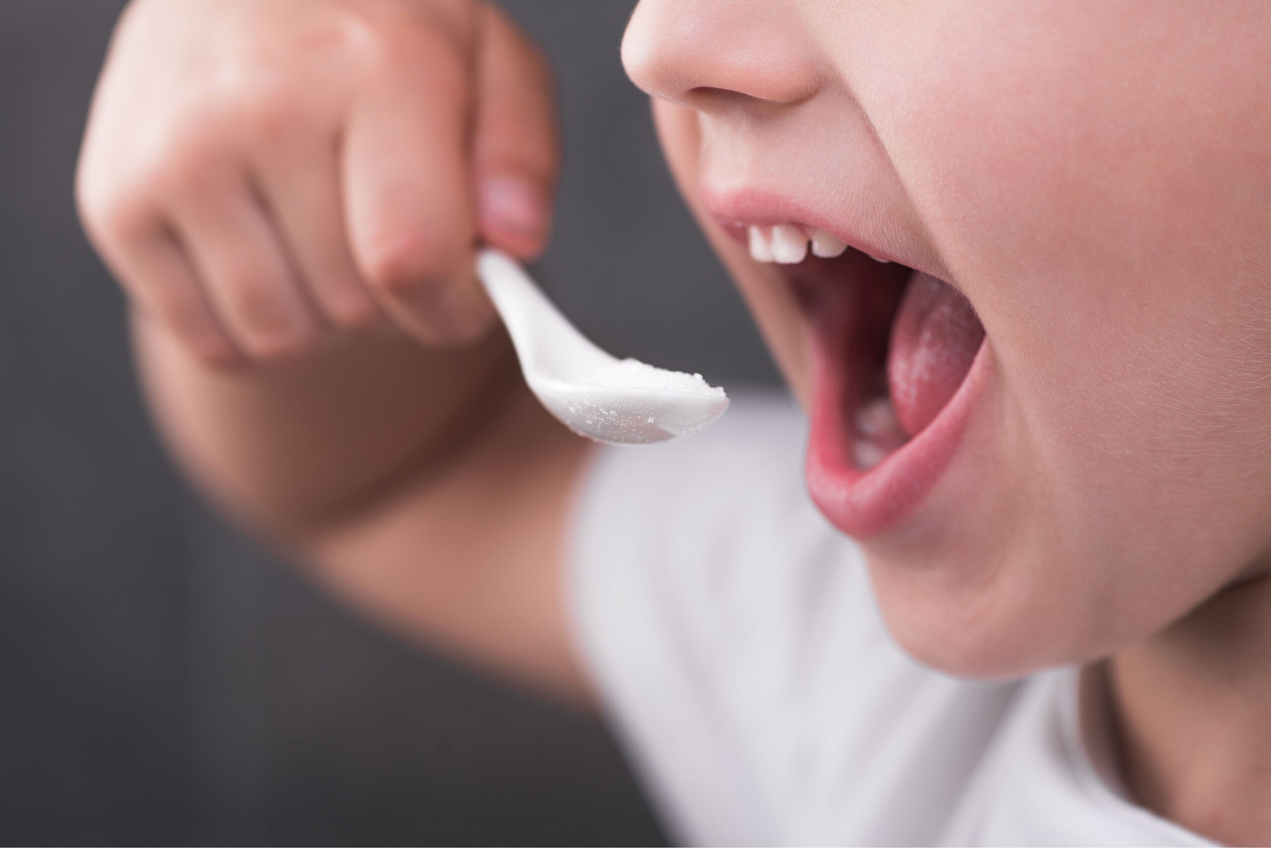 closeup-boy-open-mouth-eating-sugar-