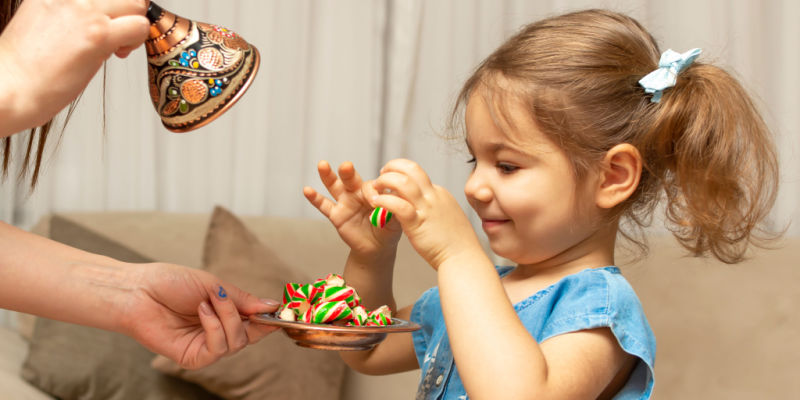 girls holds small candy cane smiles