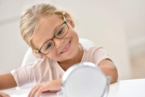 little girl trying on glasses