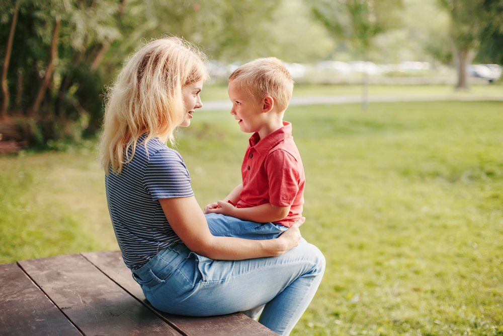 mother with child on lap, eye contact, good manners