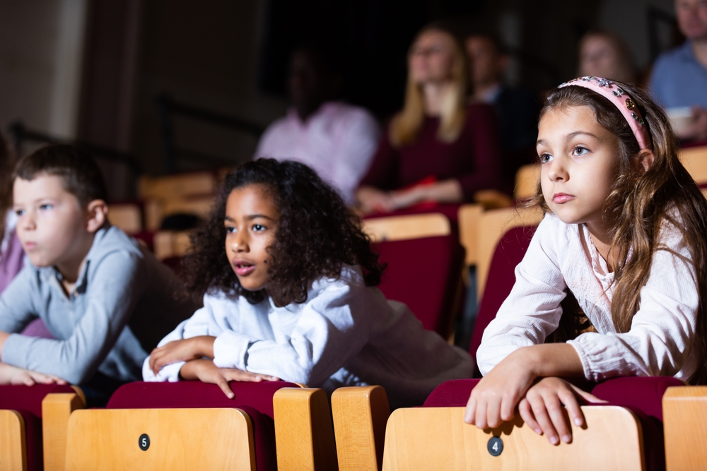 child, bored, in theater