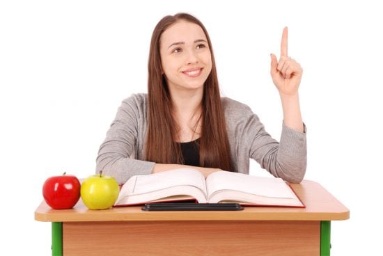 critical thinking skills involve questioning, a girl at a desk raises her hand