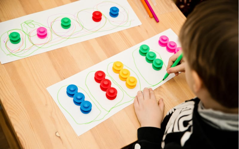 Child draws outline with colored pen