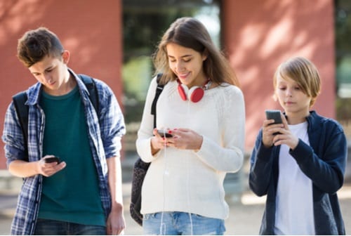 Happy kids on their smartphones