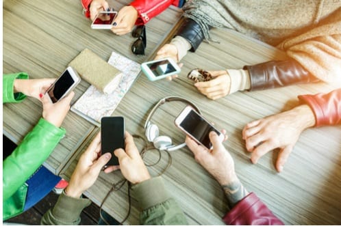 Teens texting, only hands visible