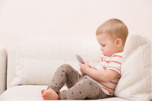 Toddler playing with toy mobile phone