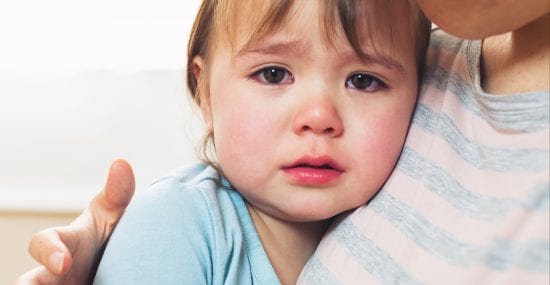 A child is comforted by mom after a power struggles dissolve into tantrum