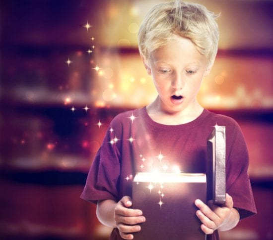 Boy has surprised expression as he opens gift box