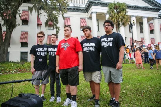 Teenage boys wear shirts commemorating the Parkland mass shooting