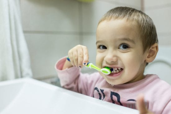 Cute little boy brushes his teeth