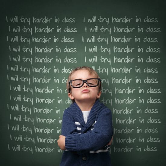 Antagonistic teachers bully students. Defiant boy with glasses in front of blackboard: I will try harder in class