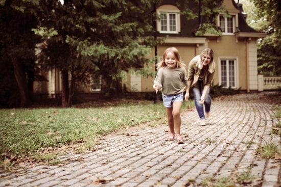 Single mom chases her young daughter, both laughing