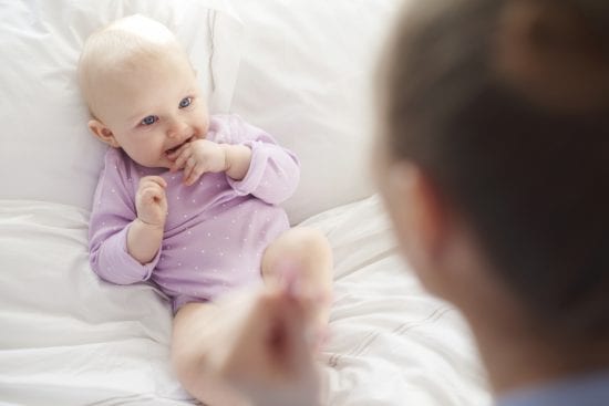 Serve and return moment between a baby and his mother