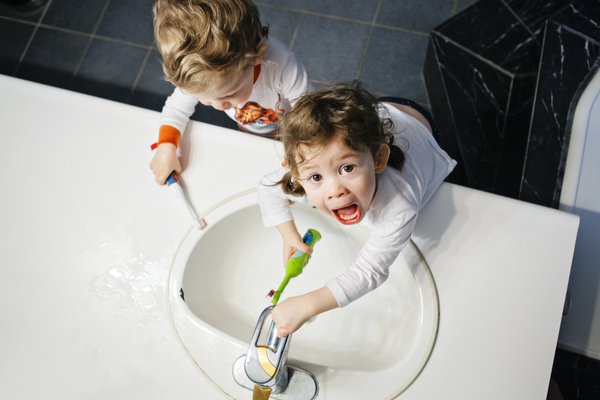 Twins brush their teeth