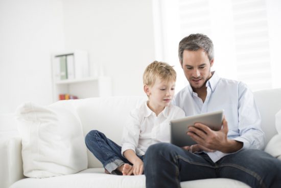 father and son surf the internet together