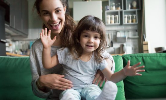 Happy babysitter with child on lap