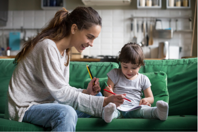 Babysitter and child do drawing activity