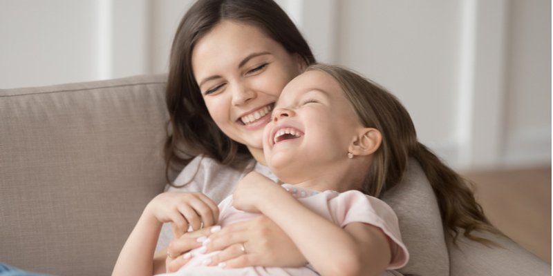 Mother tickling daughter