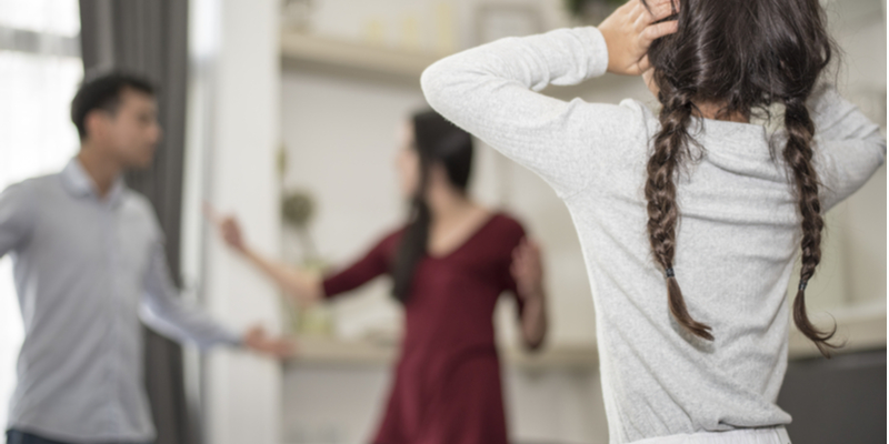 couple quarrels as little girl puts hands to ears