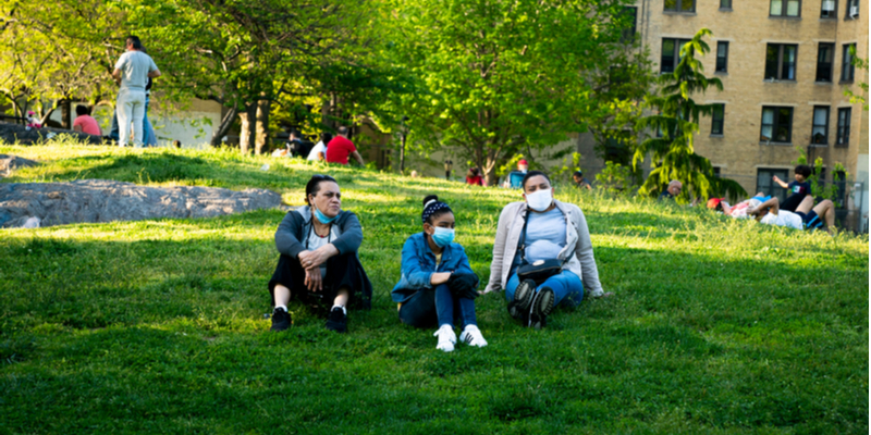 masked family in NYC park during COVID-19