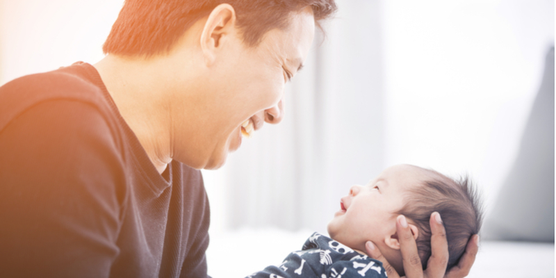 Asian Daddy and newborn smile