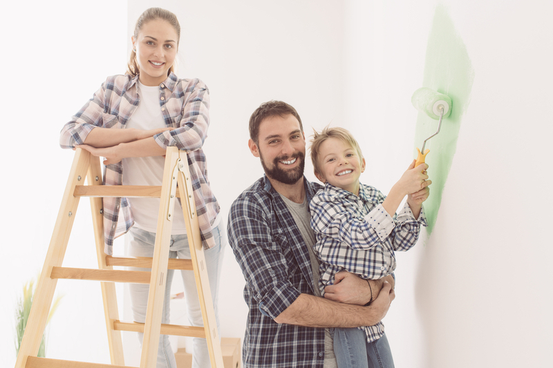 Family paints living room together