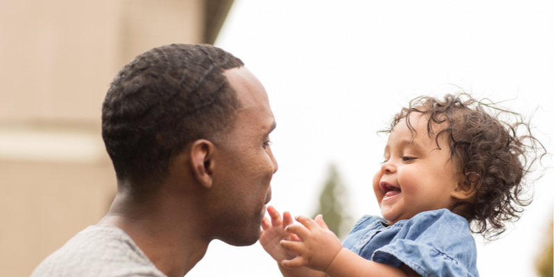 Smiling African American father and toddler