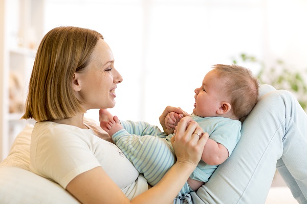 Smiling blond mother and baby