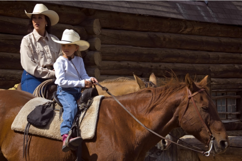 mother and daughter ride horses in Montana